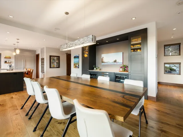 Dining area with light wood-style flooring, recessed lighting, and beverage cooler