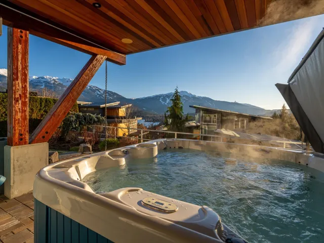 View of pool with a mountain view, a hot tub, and area for grilling