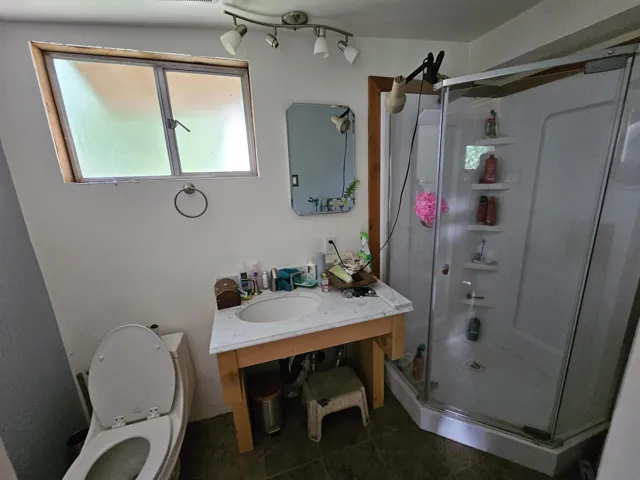 Bathroom featuring a shower stall and vanity