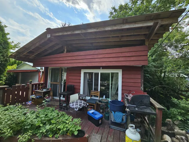 Back of house with a deck