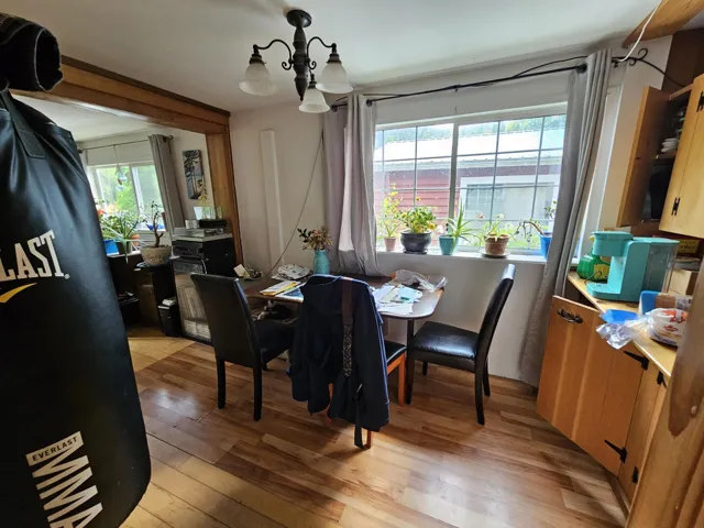 Dining room with light wood-type flooring, plenty of natural light, and a chandelier