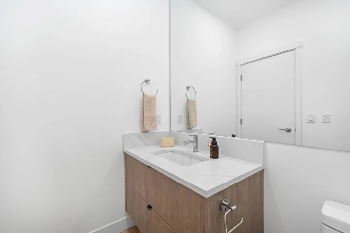 Half bathroom with vanity and toilet