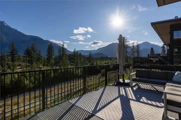 Wooden terrace featuring a mountain view, outdoor lounge area, a patio, and a wooded view