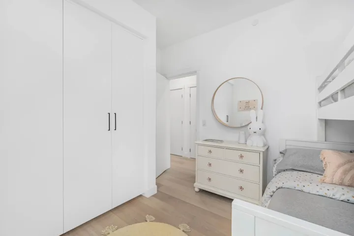 Bedroom with light wood-style flooring and a closet