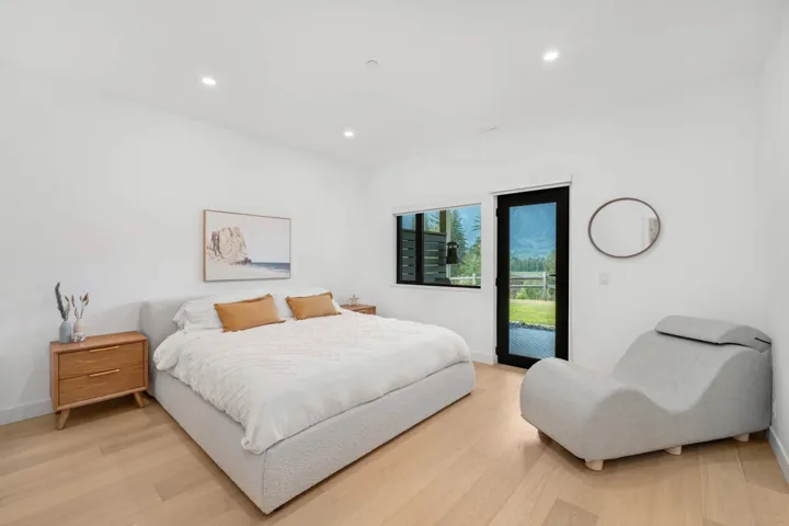 Bedroom with light wood finished floors, recessed lighting, and access to outside