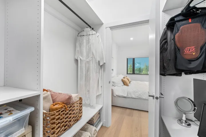 Walk in closet with light wood-style floors