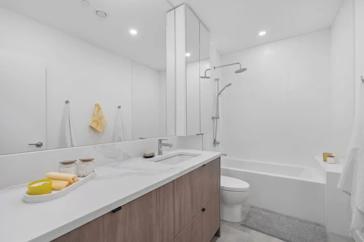 Full bath featuring vanity, bathtub / shower combination, light tile patterned floors, and recessed lighting