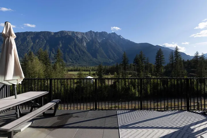 View of patio featuring a forest view and a mountain view