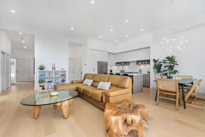 Living area with recessed lighting, light wood-type flooring, and a chandelier
