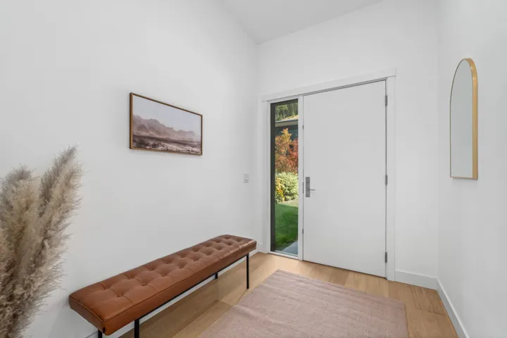 Foyer with wood finished floors and baseboards