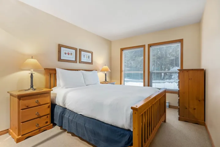 Bedroom featuring light colored carpet and baseboards