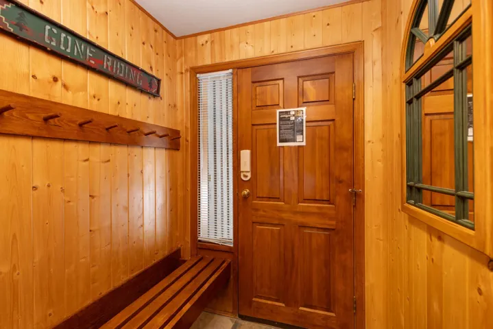 Foyer entrance featuring a sauna and wood walls