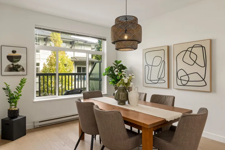 Dining space with baseboard heating and light wood finished floors