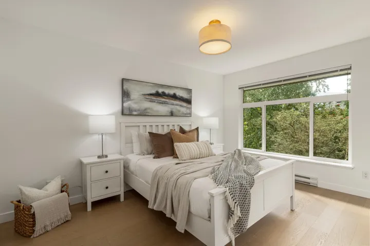 Bedroom featuring light wood-style flooring and a baseboard radiator