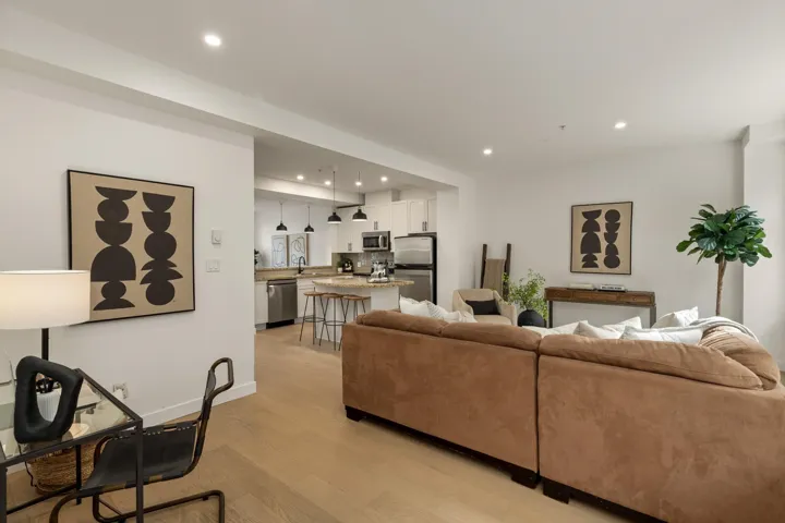 Living area with light wood-style floors and recessed lighting