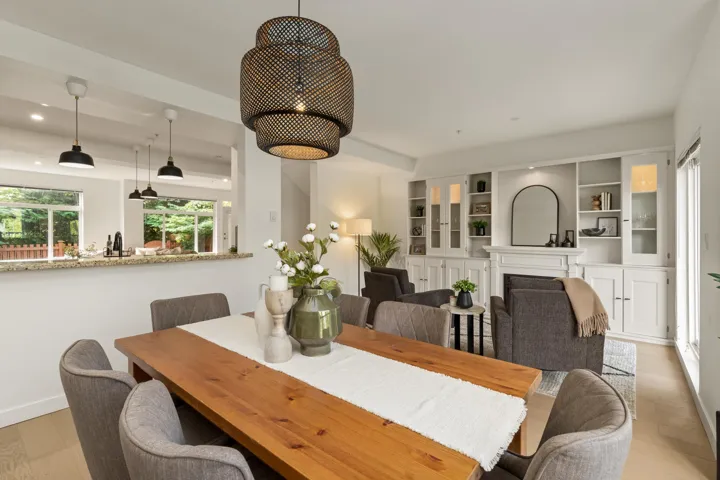 Dining room with light wood finished floors, a fireplace, and recessed lighting
