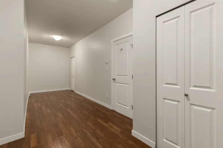 Corridor with baseboards and dark wood finished floors