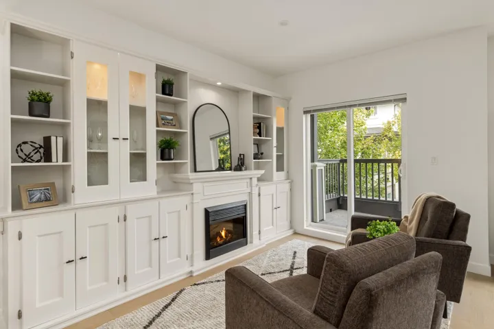 Living area featuring a glass covered fireplace and light wood finished floors