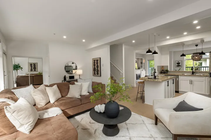 Living area with recessed lighting, stairs, and light wood-style flooring