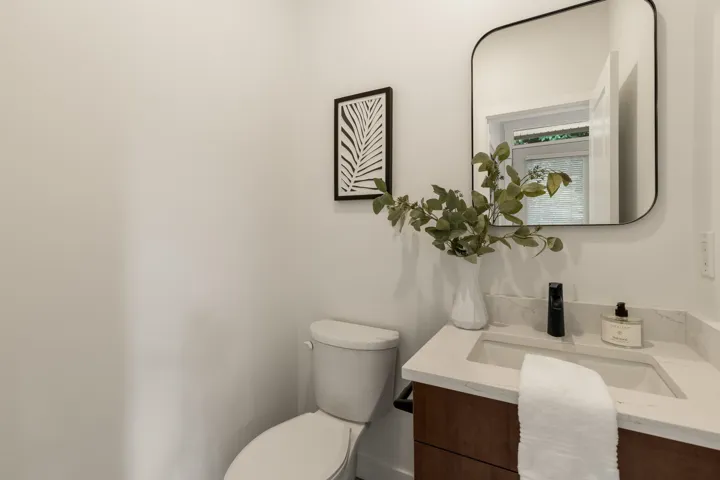 Half bathroom with vanity and toilet
