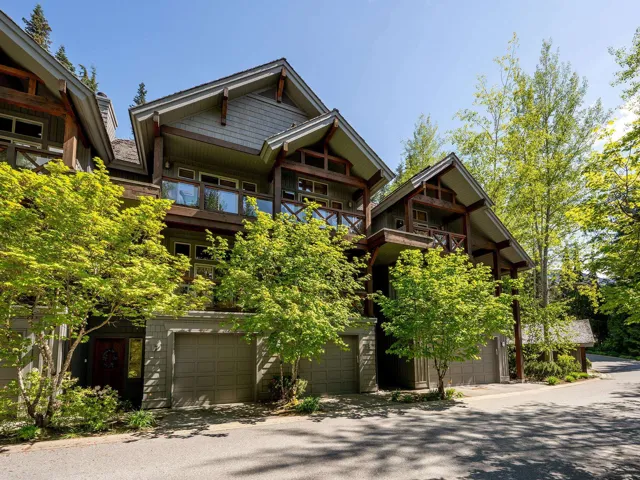 View of front of house with a garage and a balcony