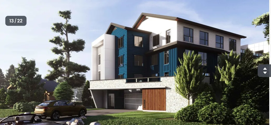 View of apartment building / complex with a garage and driveway
