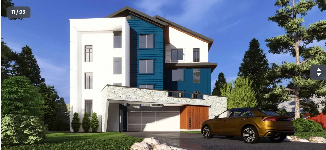 Modern home featuring a garage, decorative driveway, and stone siding