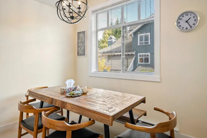 Dining space with hanging lights and baseboards