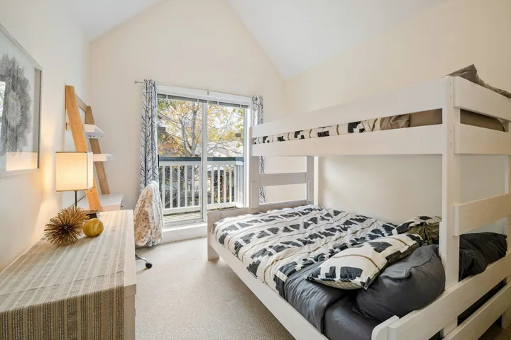 Bedroom featuring carpet floors and a high ceiling