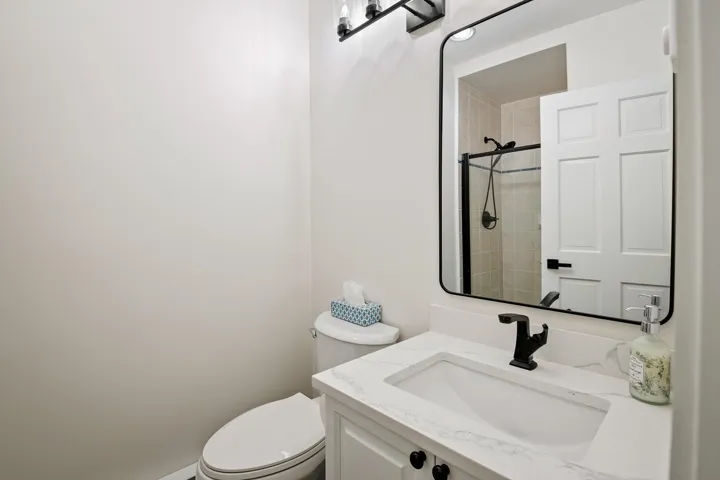 Full bath featuring vanity and a shower