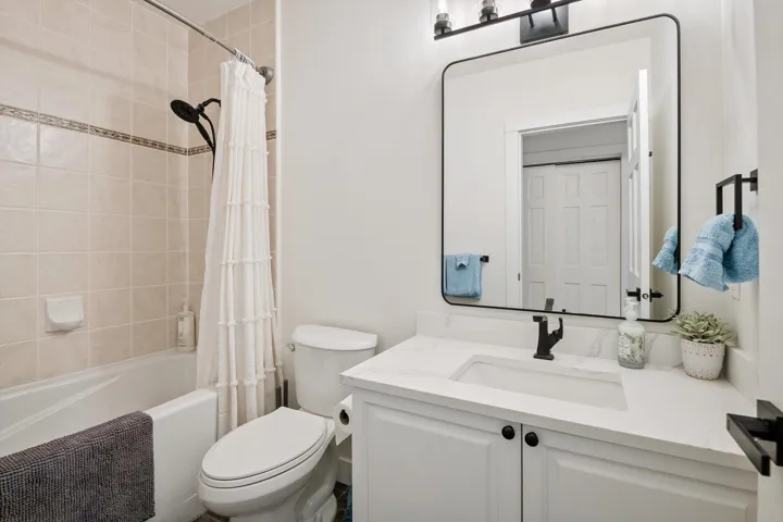 Bathroom featuring vanity and shower / tub combo