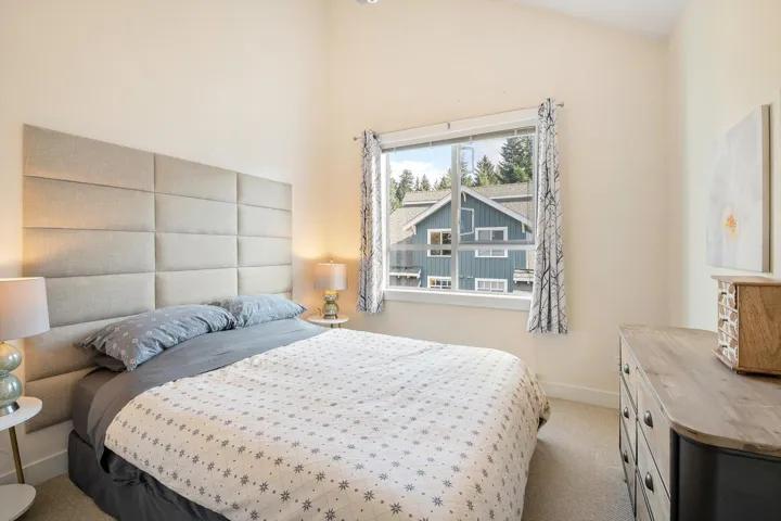 Bedroom with carpet flooring and lofted ceiling