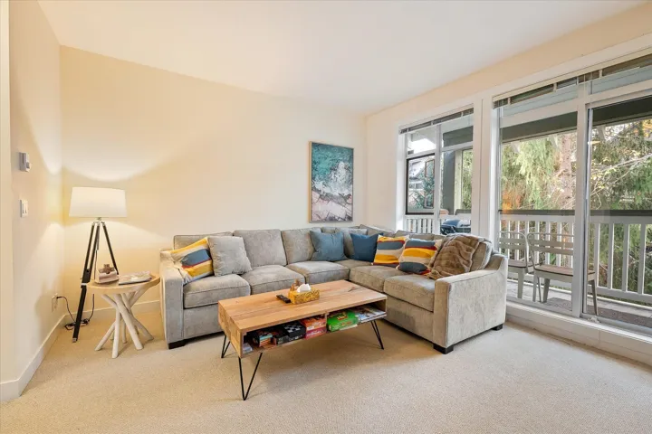 Carpeted living area featuring baseboards