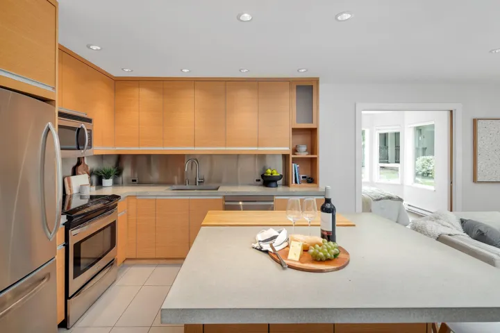 Kitchen with stainless steel appliances, recessed lighting, light tile patterned floors, backsplash, and open shelves