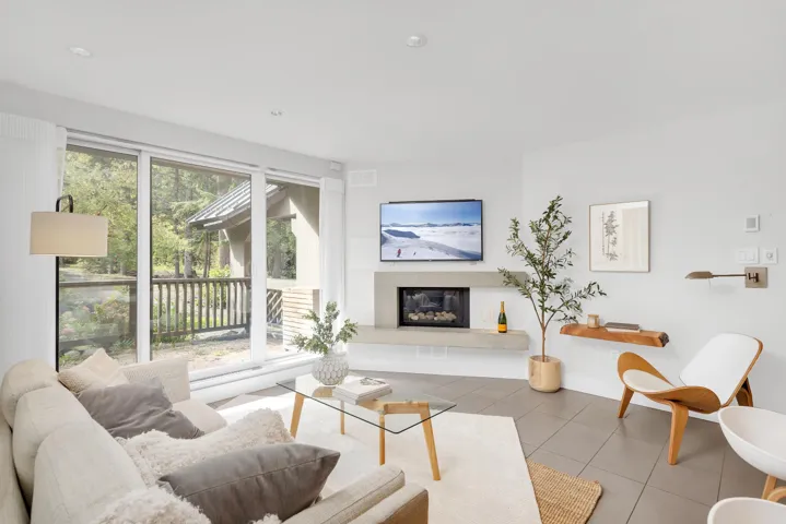 Tiled living room with a glass covered fireplace