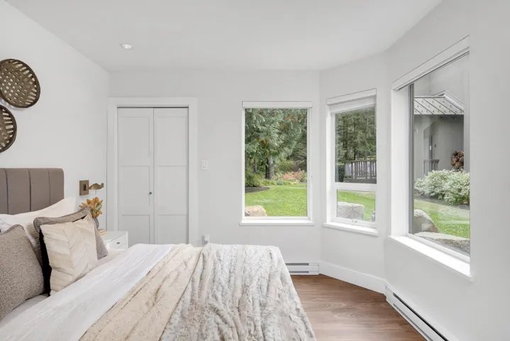 Bedroom featuring baseboard heating and wood finished floors