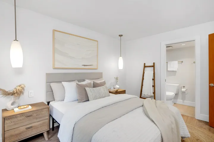 Bedroom with wood finished floors and ensuite bathroom