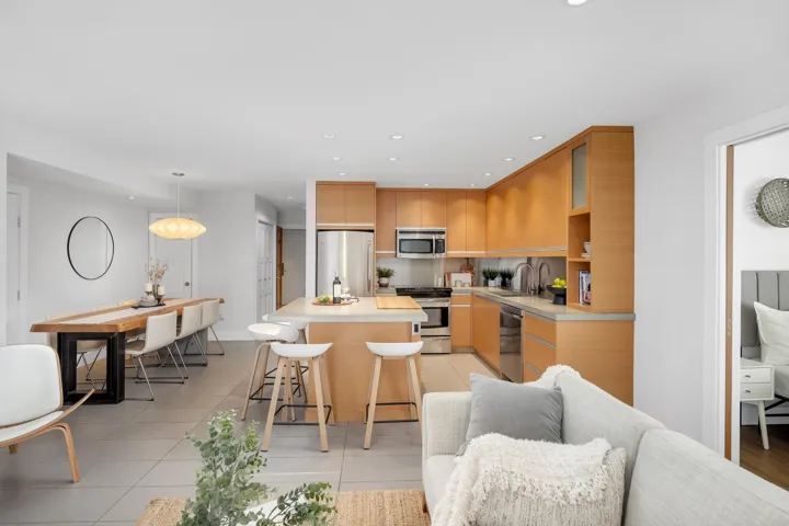 Kitchen featuring a kitchen island, light tile patterned floors, light countertops, a breakfast bar area, and recessed lighting