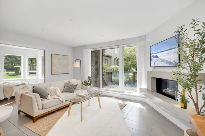 Tiled living area with a high end fireplace and recessed lighting