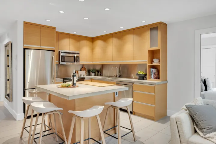 Kitchen featuring appliances with stainless steel finishes, a center island, a breakfast bar area, light countertops, and recessed lighting