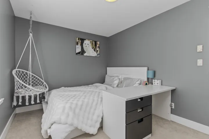 Neutral-toned bedroom featuring wall-to-wall carpeting and a recessed ceiling light