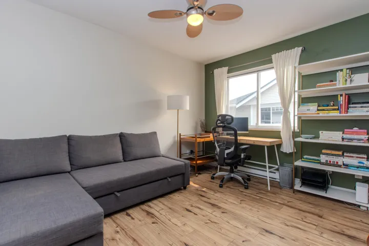 Office with light wood finished floors, a baseboard radiator, and ceiling fan
