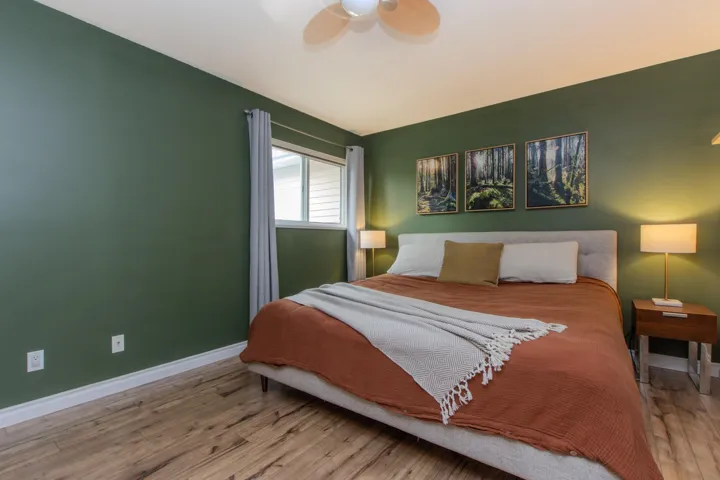 Bedroom featuring wood finished floors and a ceiling fan