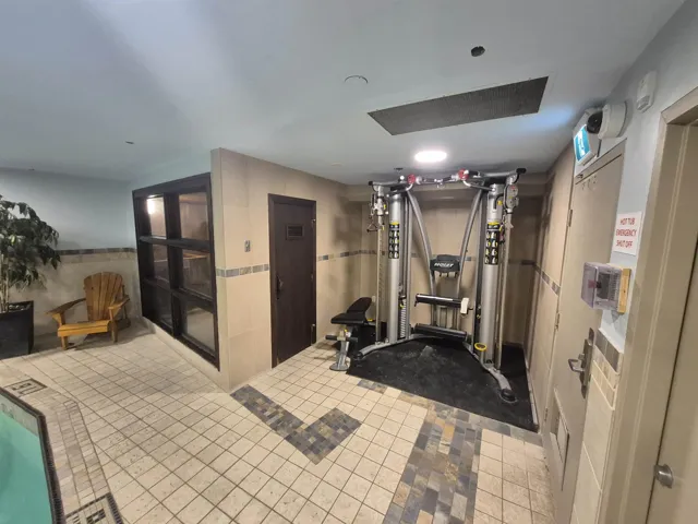 Workout room with tile walls and light tile patterned floors