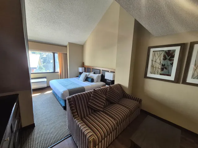 Bedroom featuring a textured ceiling and vaulted ceiling