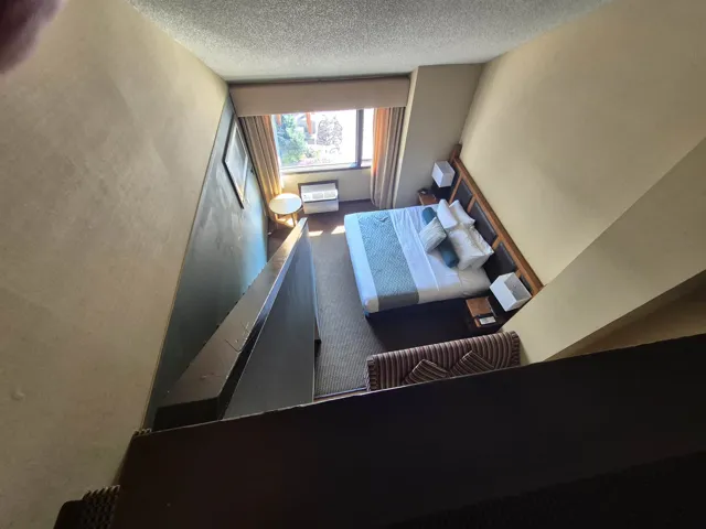 Staircase with carpet floors and a textured ceiling