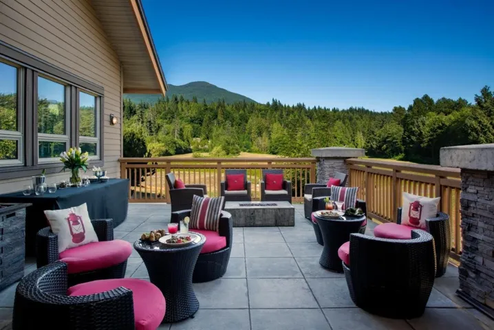 View of patio with a fire pit and a forest view