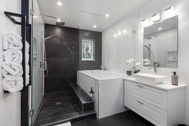 Full bath featuring a shower stall, vanity, a garden tub, dark tile patterned flooring, and recessed lighting