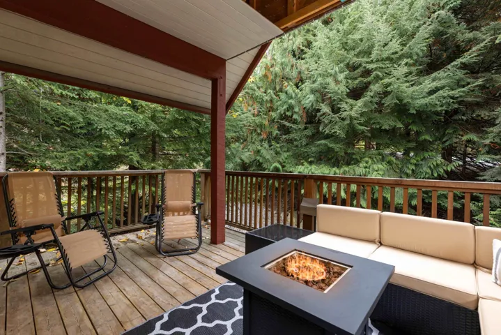 Deck featuring an outdoor living space with a fire pit