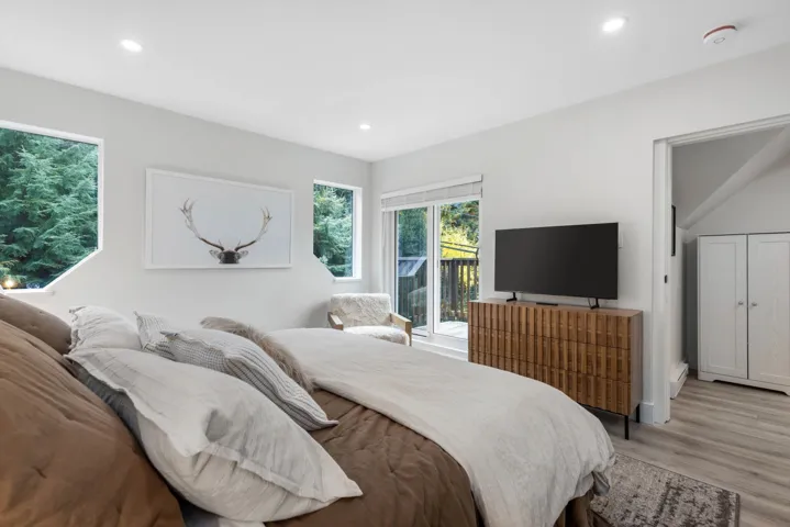 Bedroom with access to outside, recessed lighting, wood finished floors, and a baseboard radiator
